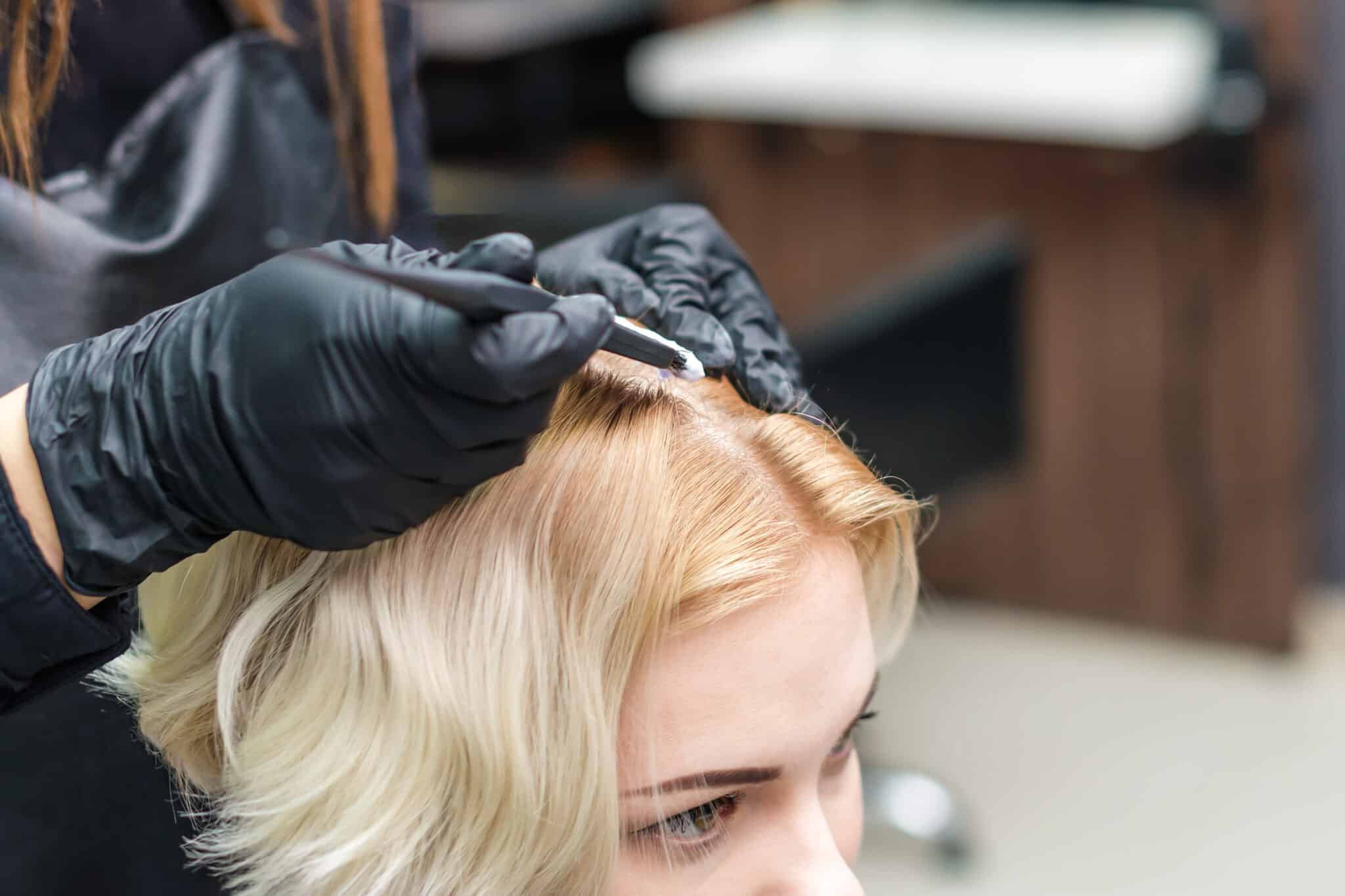 Hairdresser coloring hair.